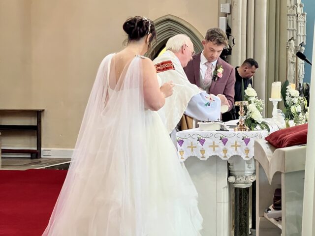 Bride and Groom light a wedding candle - Catholic Church ceremony