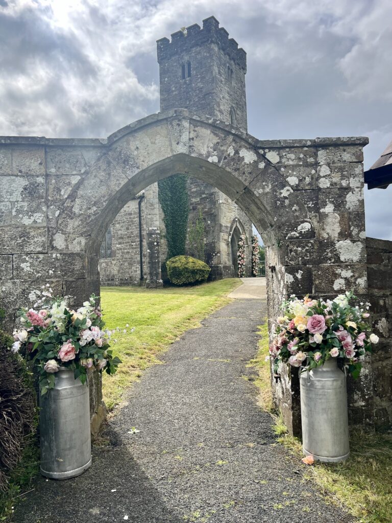 Exterior of St John Church Pontsian in West Wales. with flowers by the entrance for a wedding