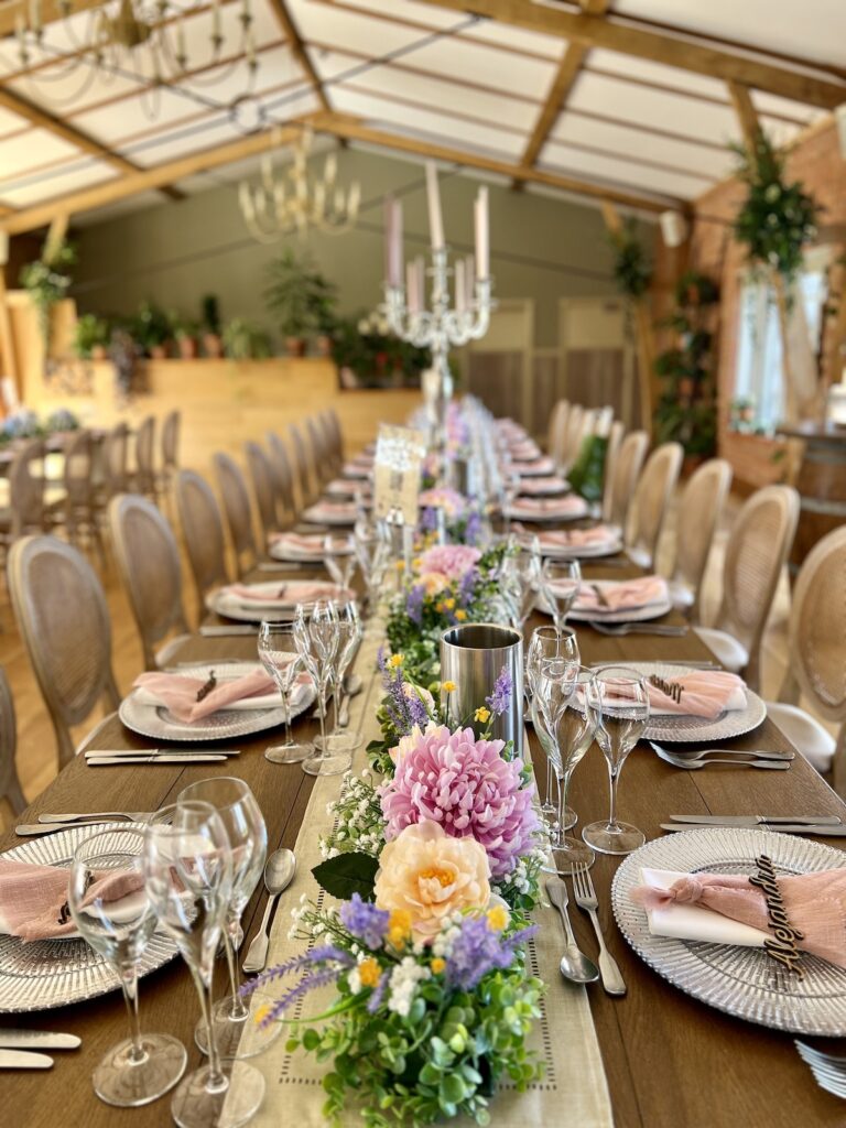 Wedding Breakfast layout with floral arrangement on the tables at Cider Mill Barns