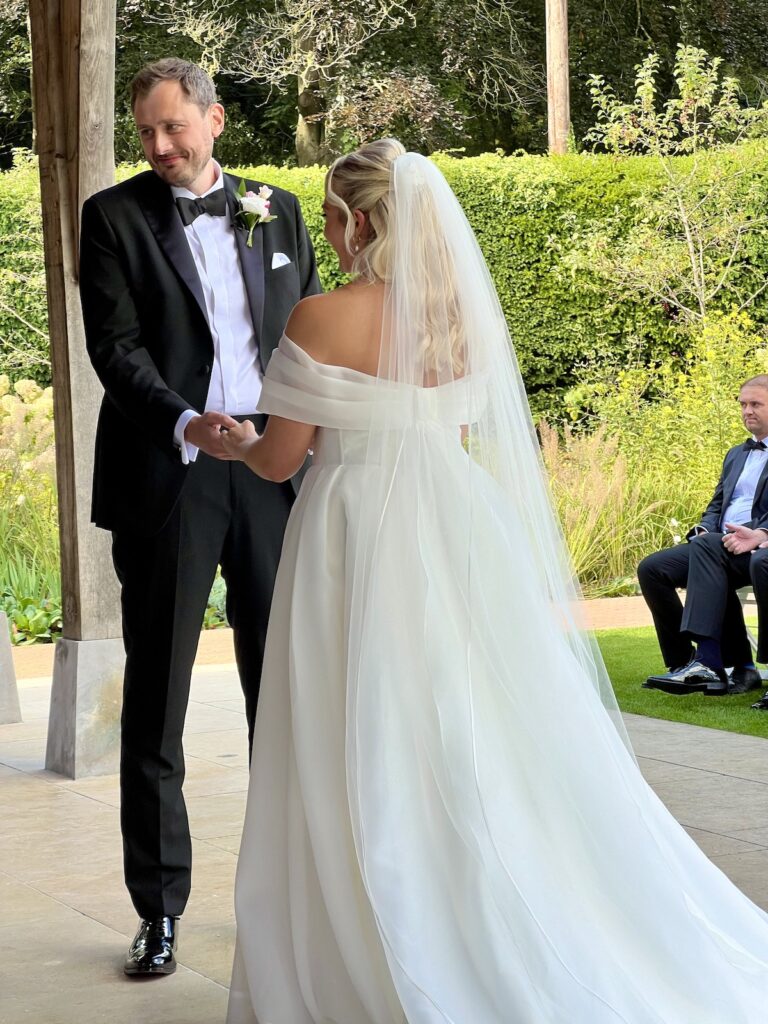 Bride and Groom during ceremony - The Post Barn Newbury