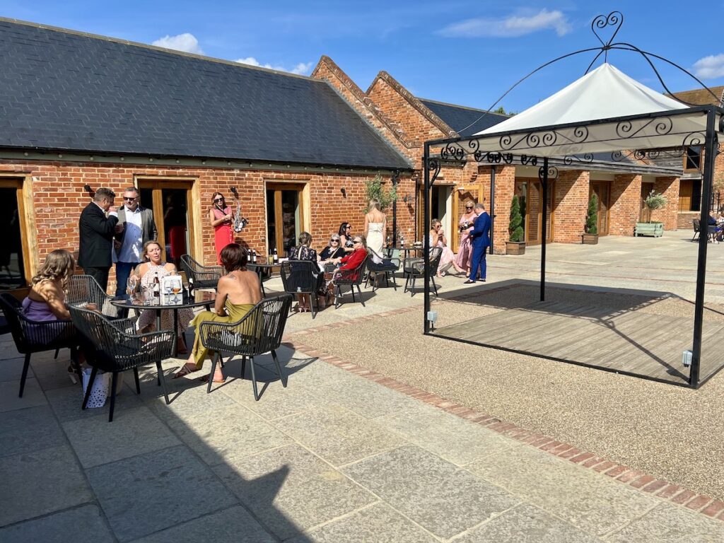 Outdoor Drinks reception with musician playing sax