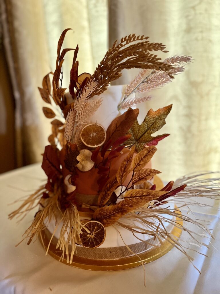 Wedding cake with autumnal decoration at Orcharleigh House near Frome in Somerset