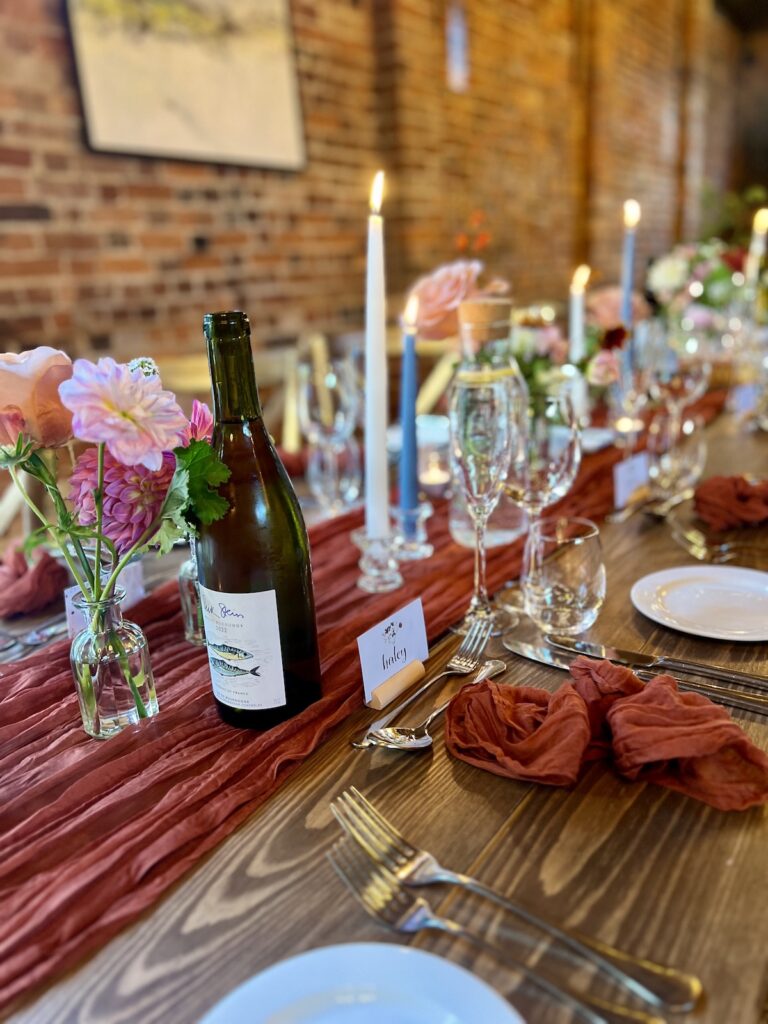 Wine bottle and candles for wedding meal