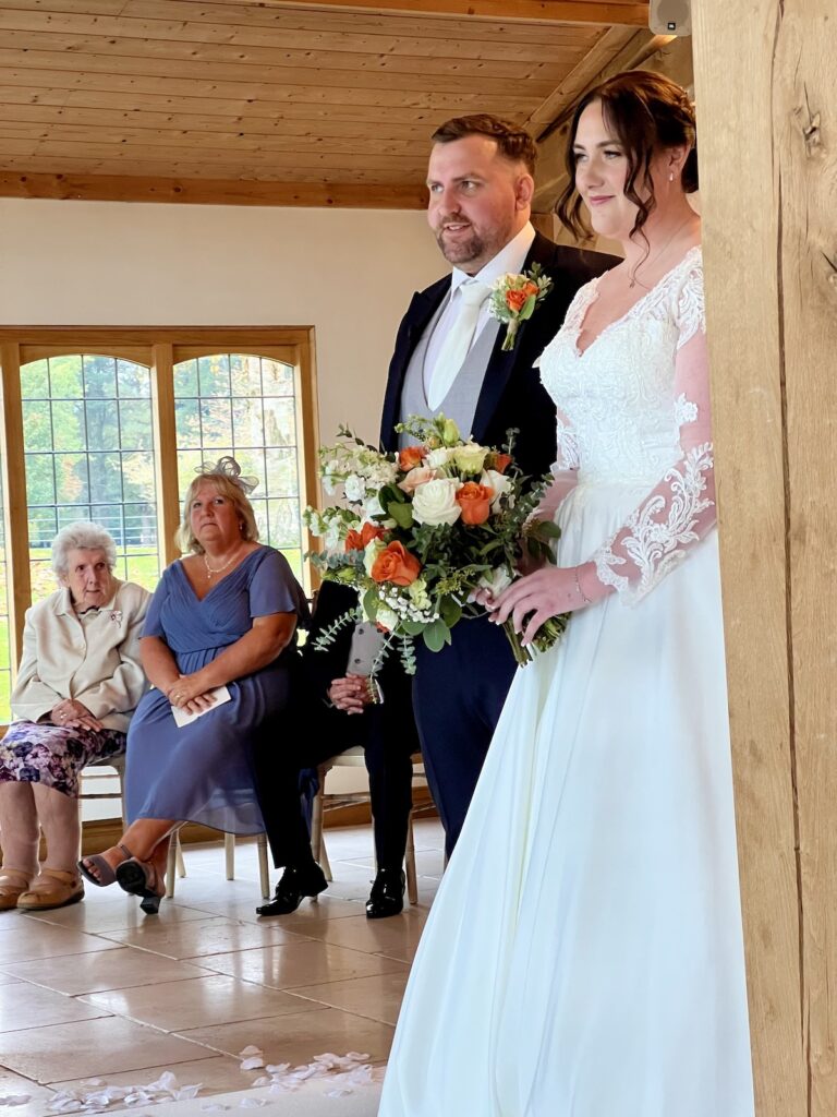 Bride and Groom wedding ceremony with autumnal flowers at Coleshaw Hall