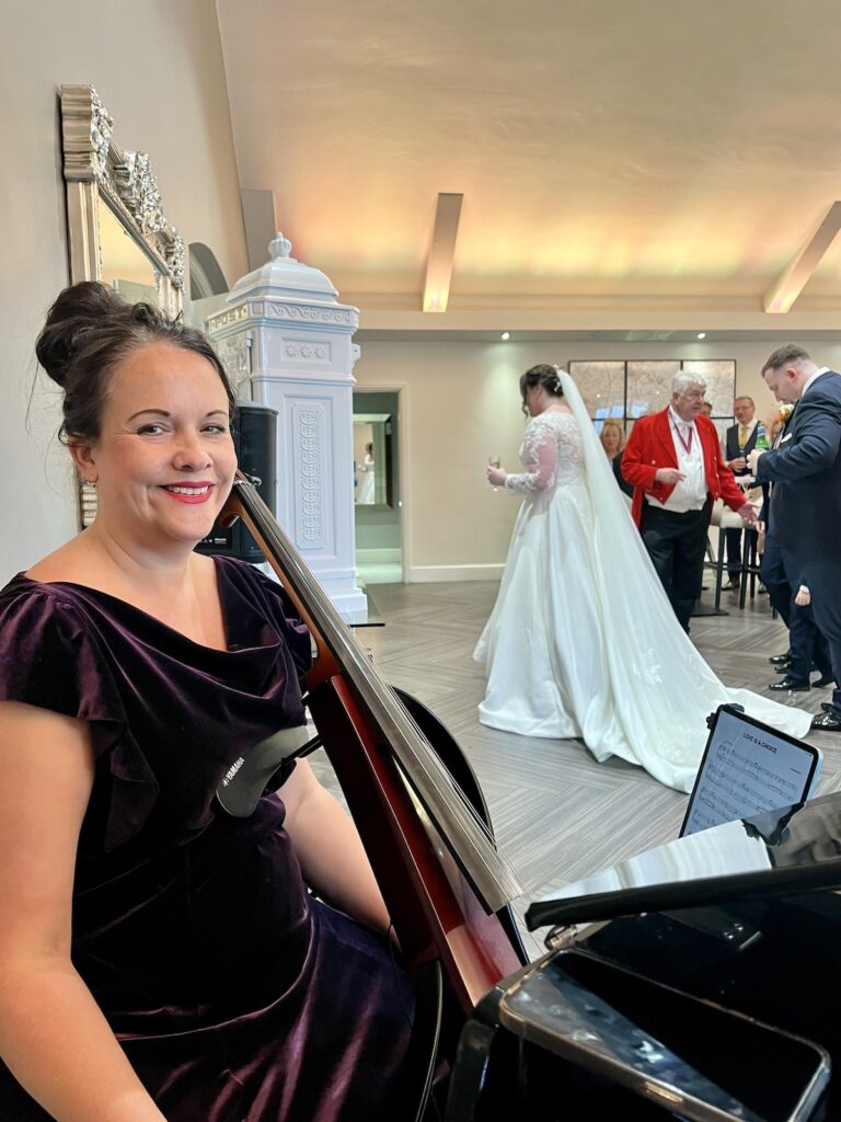 Anne Marie Cellist for JAM Duo at Coleshaw Hall with Bride in Background