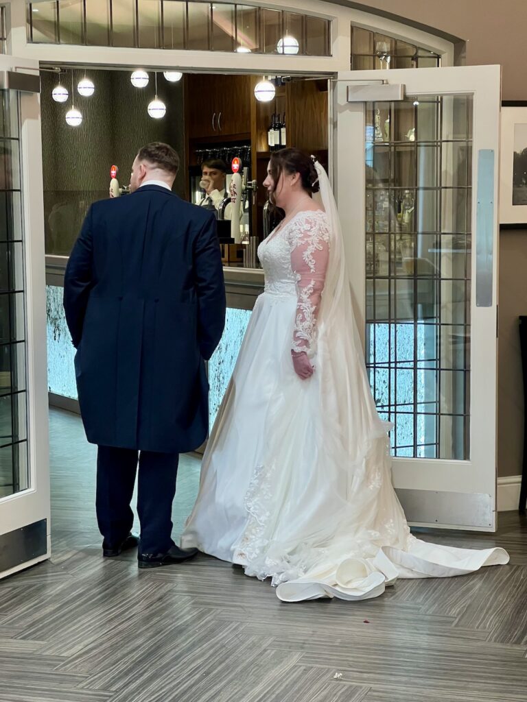 Bride and Groom waiting to be announced into the meal at Coleshaw Hall