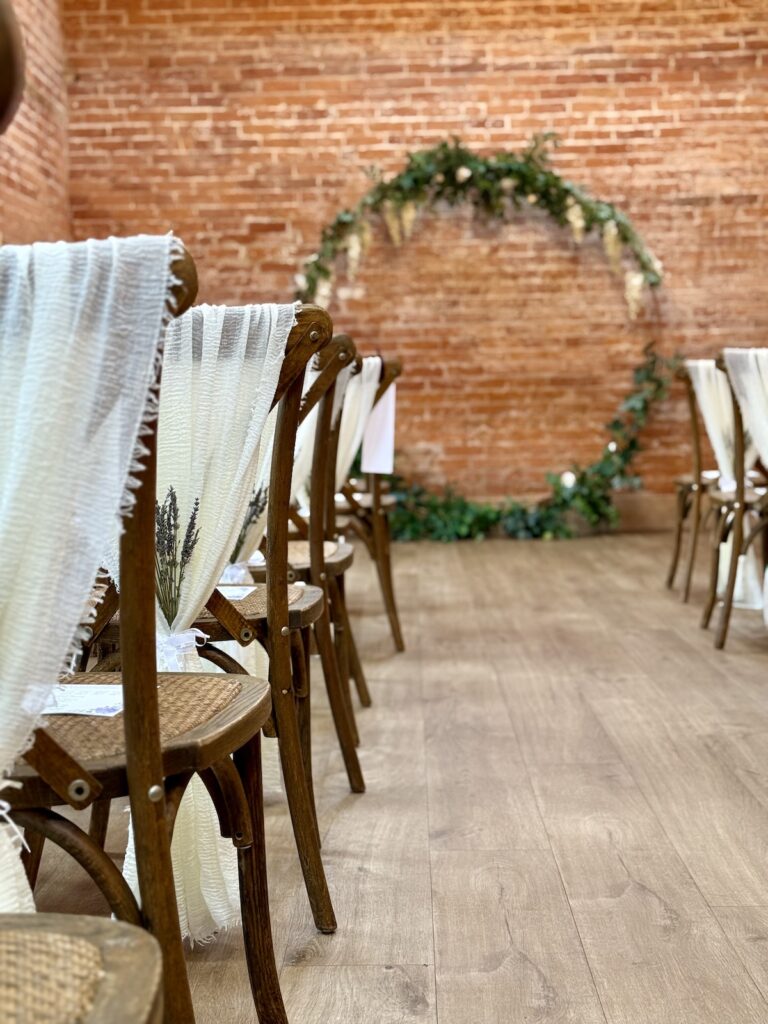 Wedding Chairs with white sashes in the ceremony room at Abbots Court, Dorset