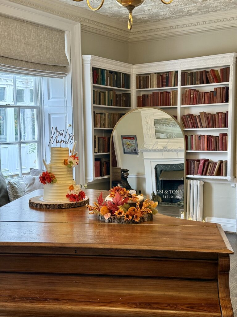 Wedding cake and flowers on a grand piano at Chilston Park Hotel