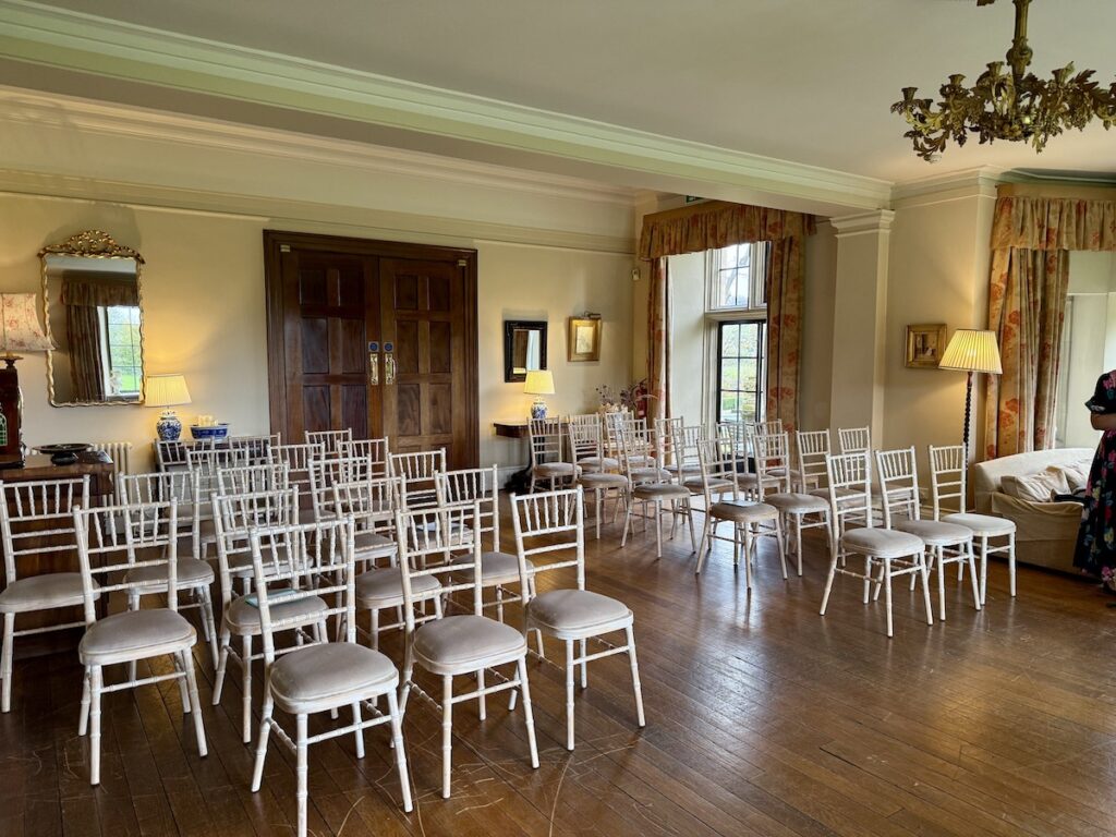 Wedding ceremony room with chairs set out at Llangoed Hall in Wales