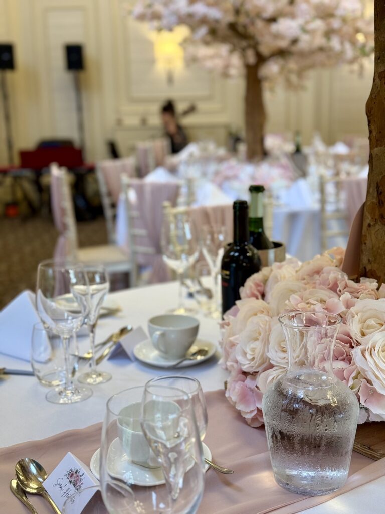 Wedding breakfast table with pink flowers